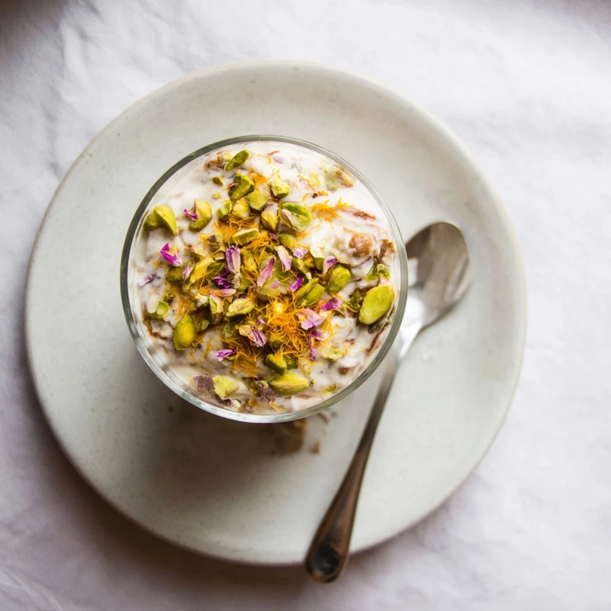 Creamy Lebanese date blossom mousse topped with crushed pistachios and delicate rose petals