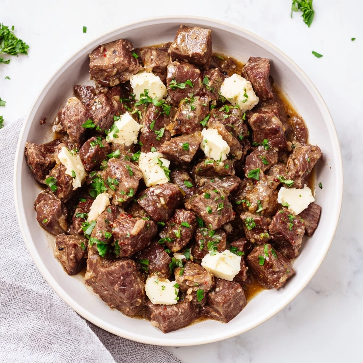Juicy slow cooker steak bites with golden seared edges and savory herb broth