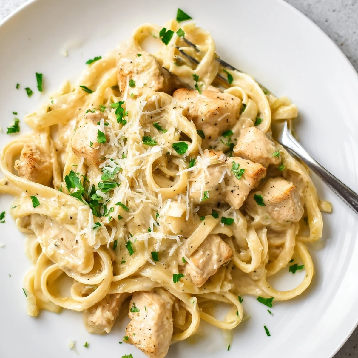 Creamy Instant Pot Chicken Alfredo with tender pasta pieces coated in rich parmesan garlic sauce