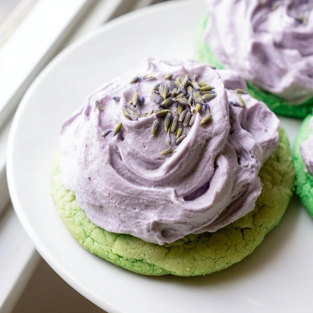 Matcha sugar cookies with swirled purple lavender buttercream garnished with delicate dried lavender buds