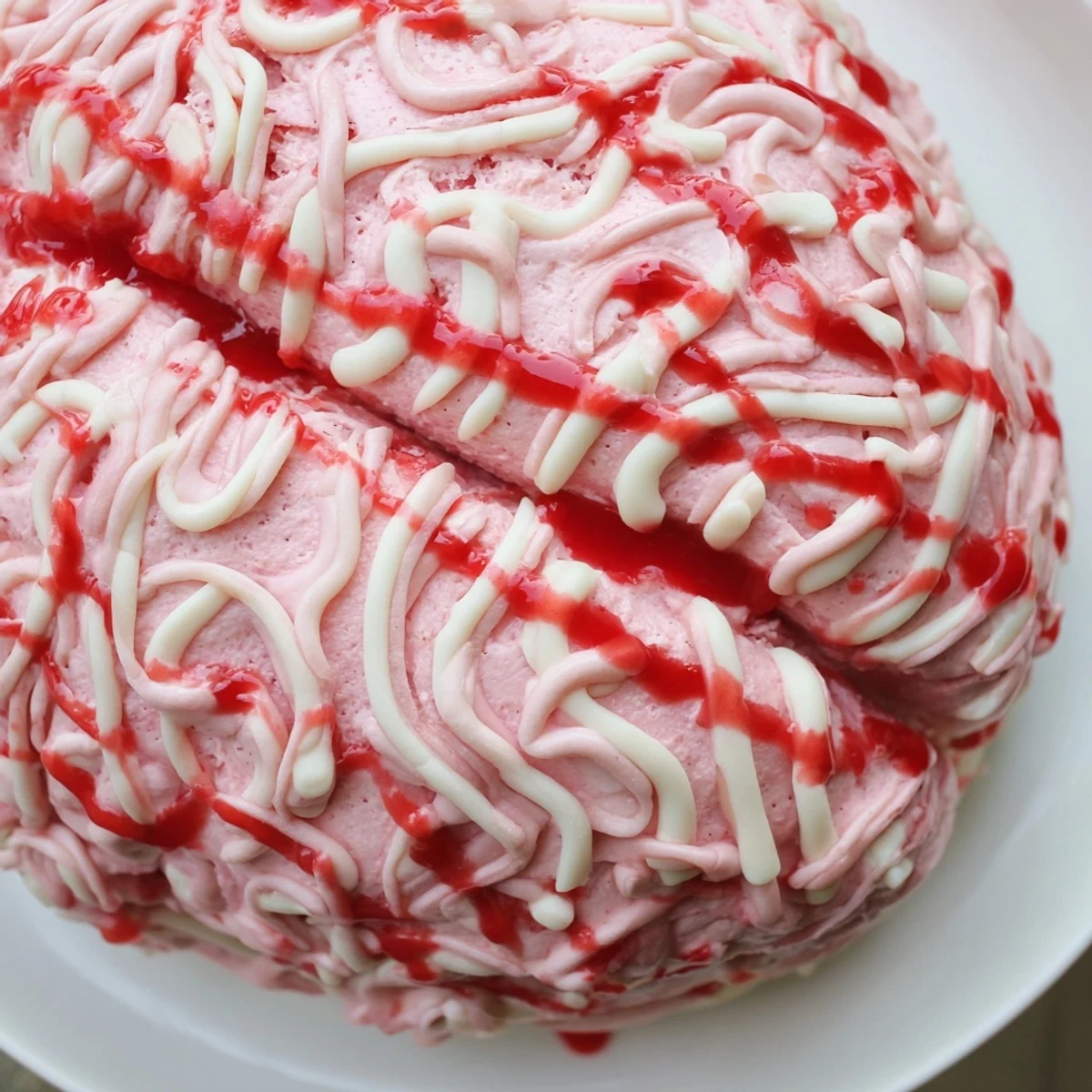 No Bake Strawberry Cheesecake Brain sliced open to reveal creamy pink strawberry filling