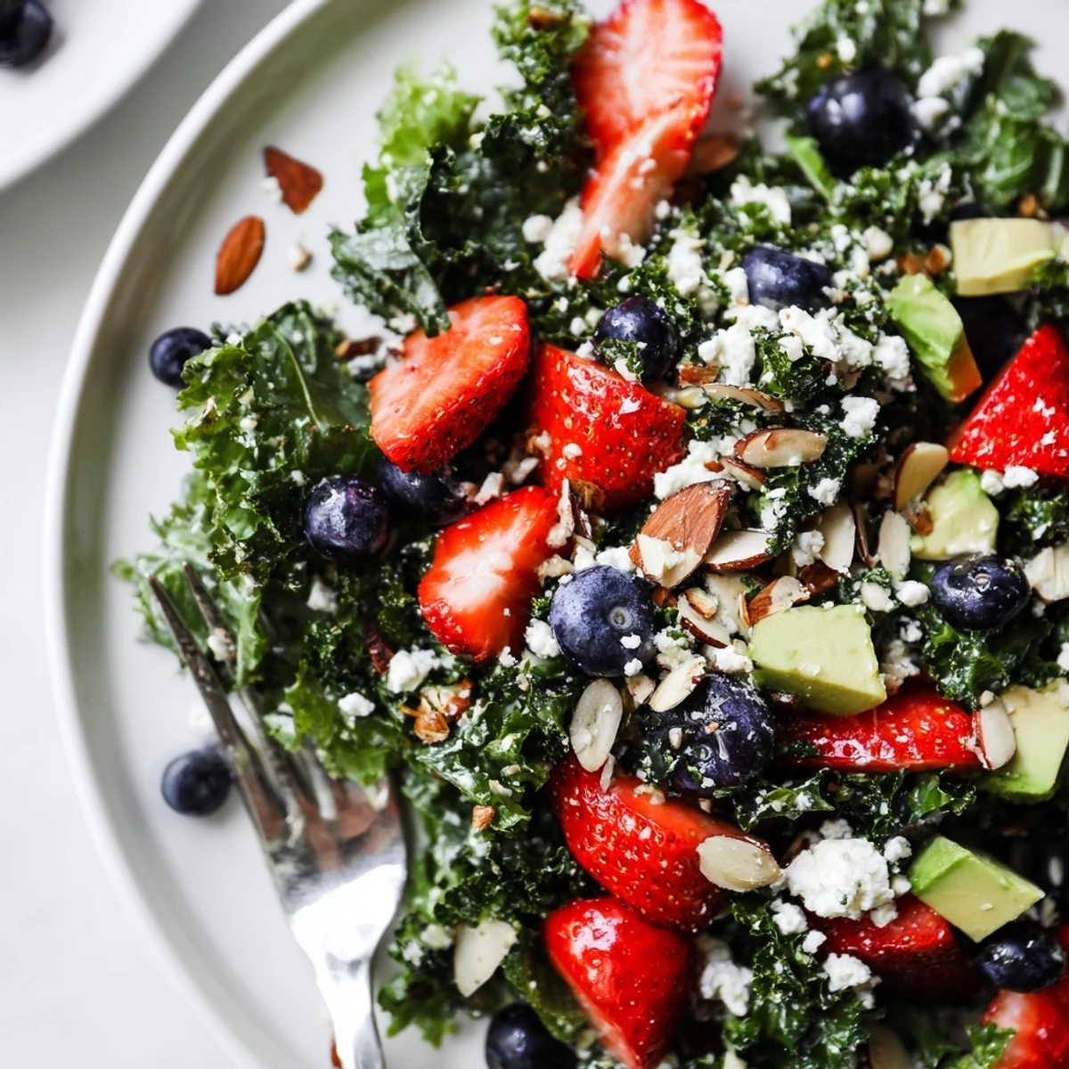 Chopped kale tossed with juicy strawberries and a golden lemon-honey vinaigrette