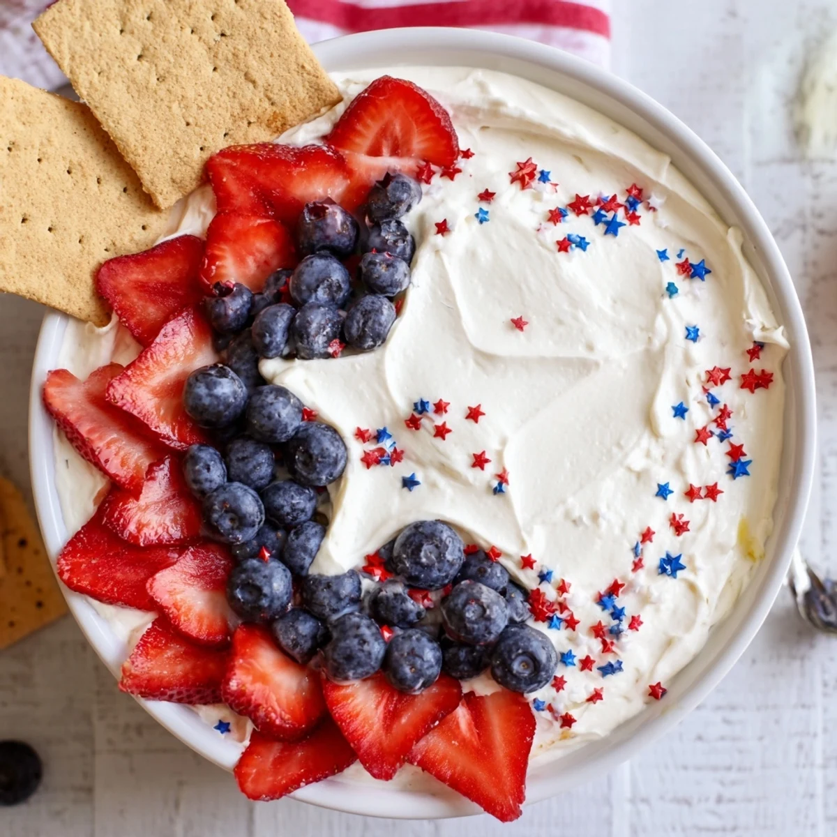 Creamy Star Spangled Cheesecake Dip arranged in flag pattern, ready for summer gatherings