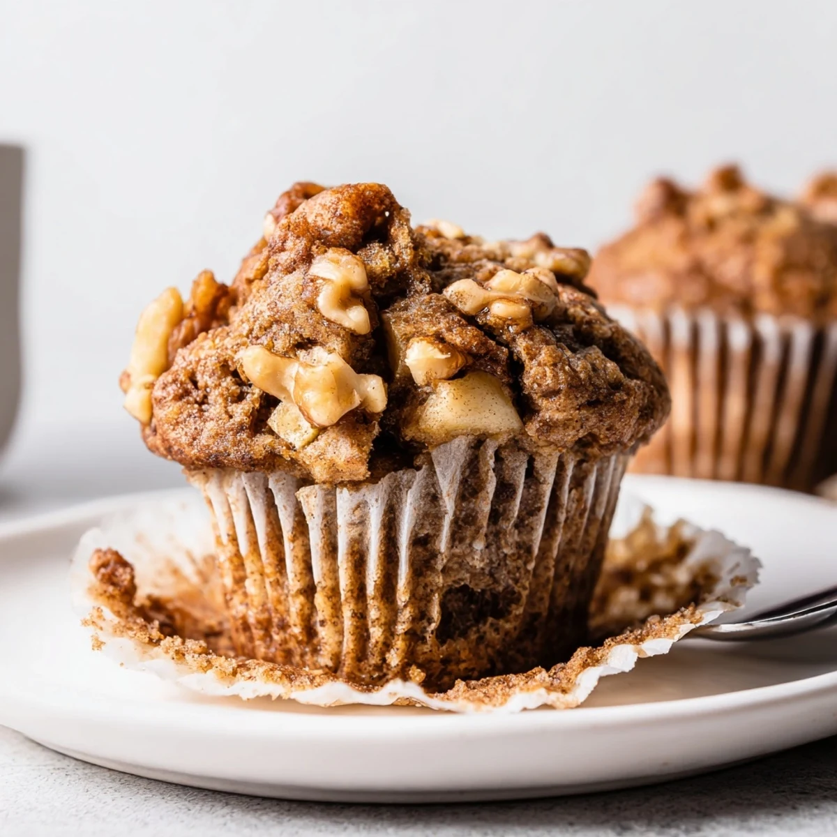 Sliced Healthy Apple Cinnamon Greek Yogurt Muffins served with honey drizzle