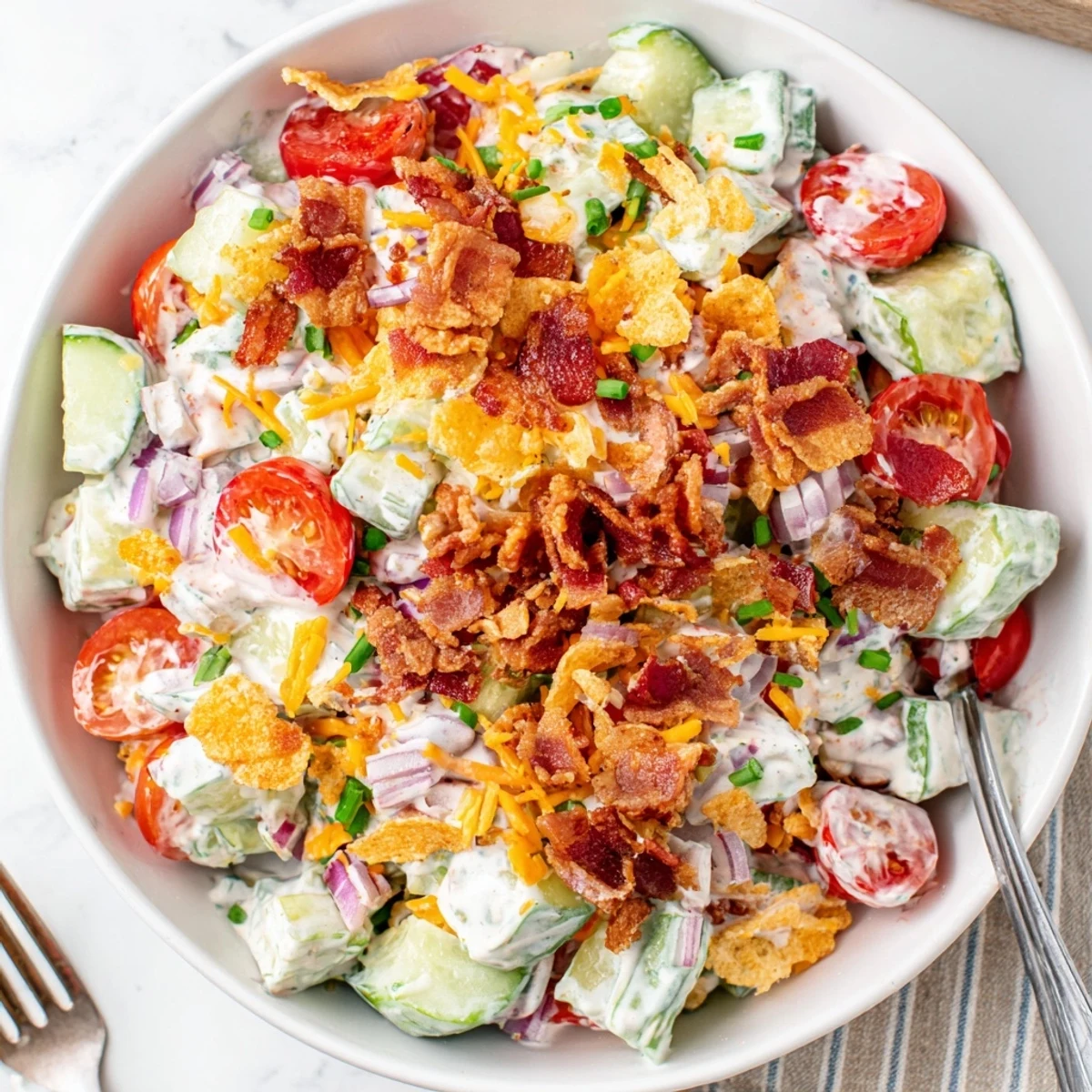 Picnic-ready Cucumber Ranch Crack Salad tossed with fresh chives and crispy bacon