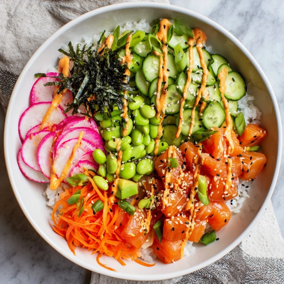 Hawaiian-style salmon and avocado poke bowl arranged with crisp vegetables and spicy mayo
