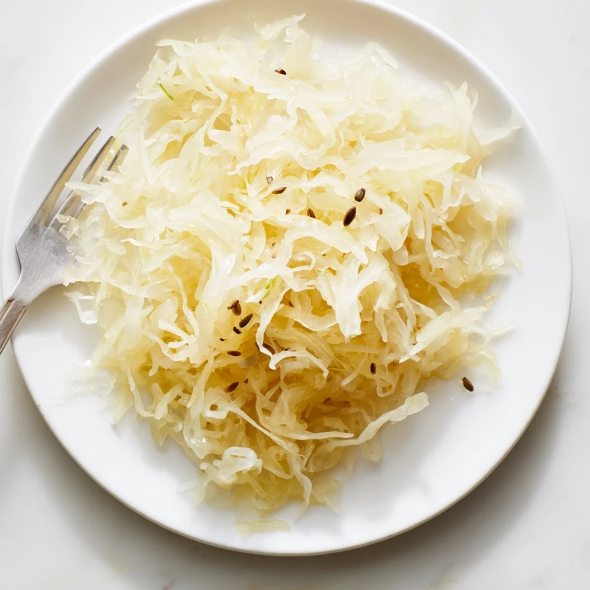 Homemade sauerkraut packed tightly into a fermentation crock with weights pressing down