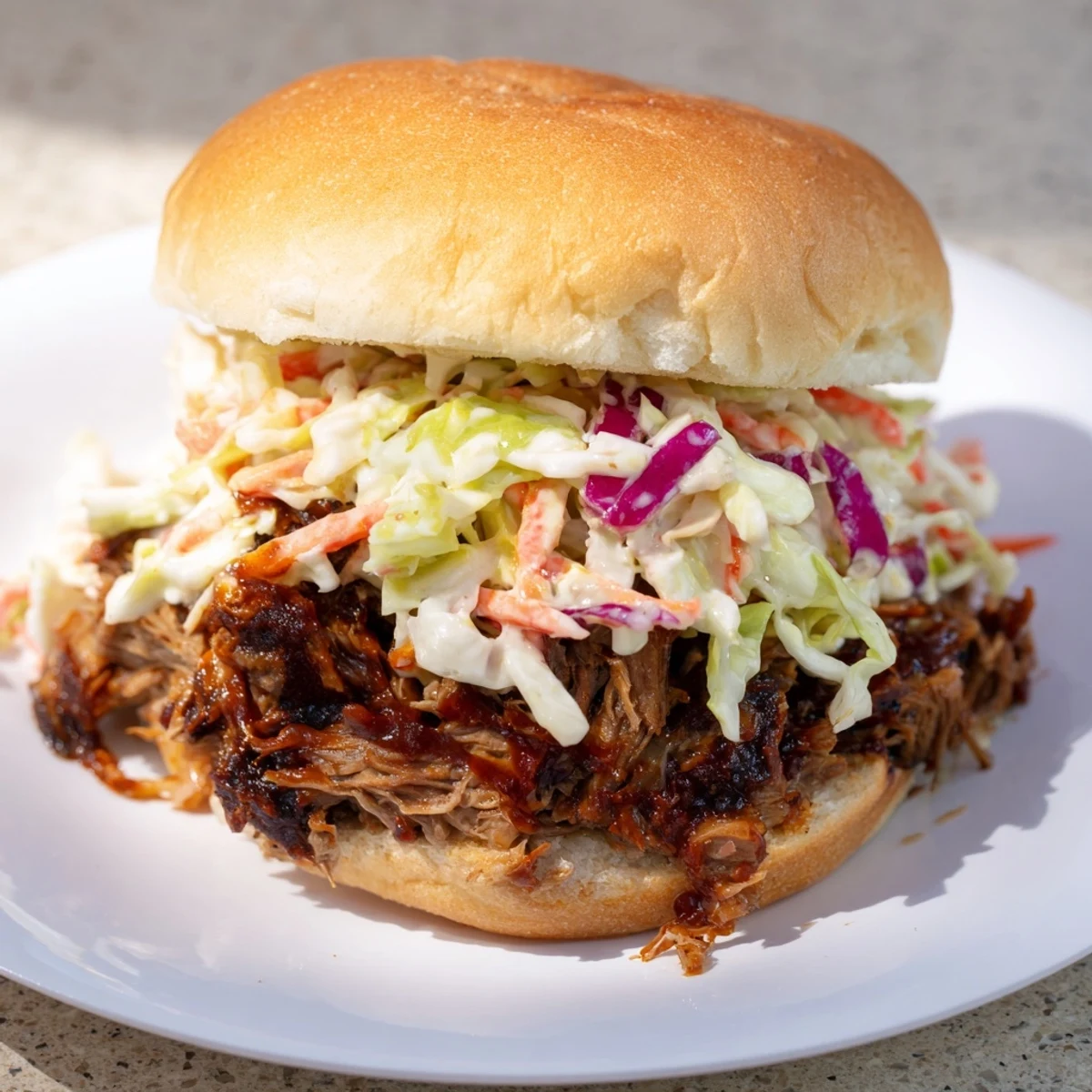 Hearty BBQ beef sandwich overflowing with fresh cabbage coleslaw and rich smoky sauce