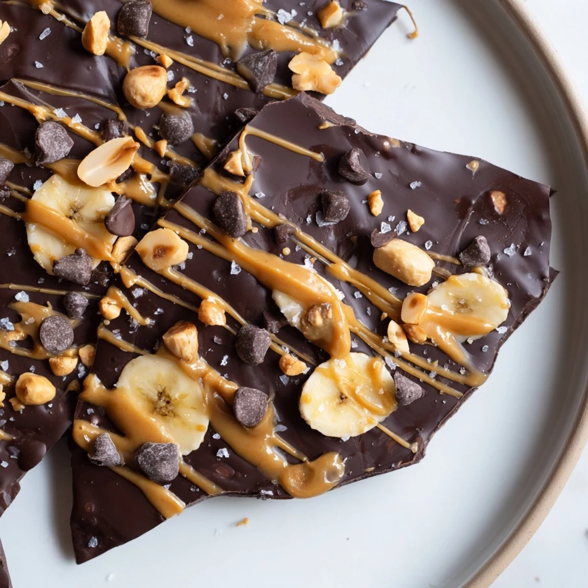 Creamy banana slices beneath glossy dark chocolate in this viral chocolate banana bark