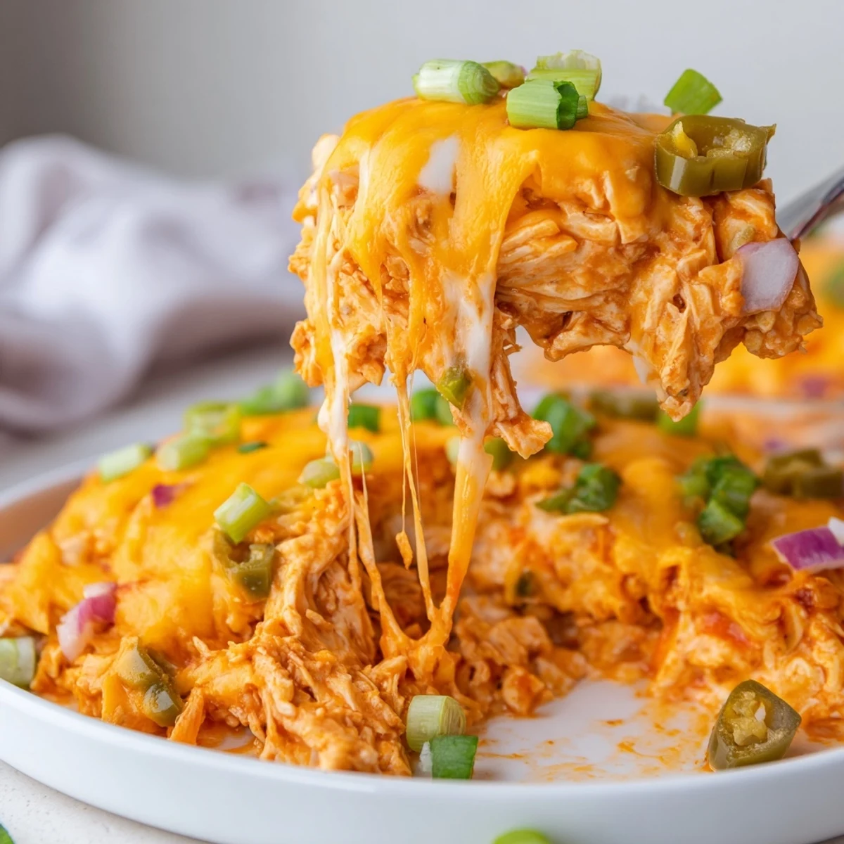 Golden bubbling jalapeno buffalo chicken casserole fresh from the oven with melted cheddar