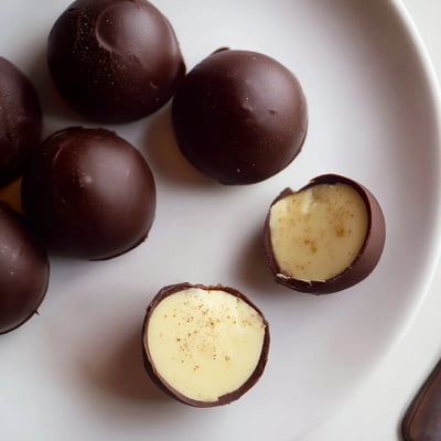 Plated Dark Chocolate Eggnog Truffles with creamy spiced centers, perfect for gifting