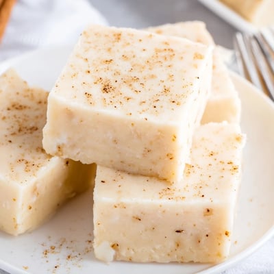 Silky white Eggnog Fudge cooling in pan, ready to cut into squares