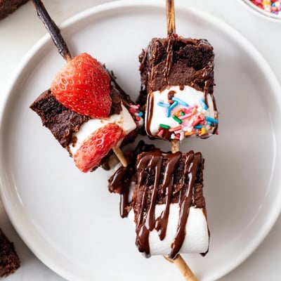Platter of Sweet Strawberry Brownie Kabobs, juicy strawberries and toasted marshmallows.