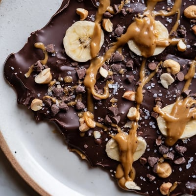 Viral chocolate banana bark topped with crushed nuts and a flaky salt finish